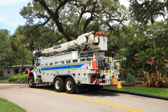 Florida Power and Light bucket truck parked in a residential neighborhood, while workers fix the downed power line, in Fort Lauderdale, Florida, USA.