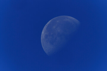 The Moon against a blue sky.