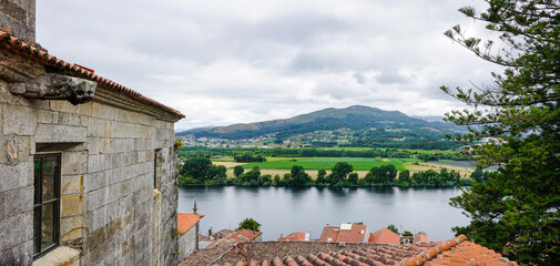 Rustic view of stone houses and the river in the city of Tui, in Portugal