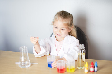 Little girl doing a science experiment. Kindergarten. Education concept