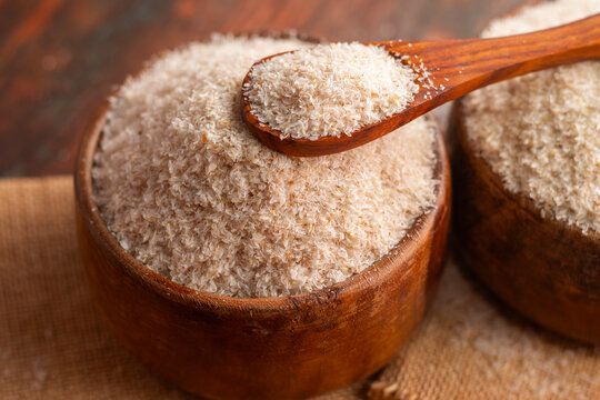 selective focus of Psyllium Husk in Wooden Bowl: Natural Fiber for Digestive Health
