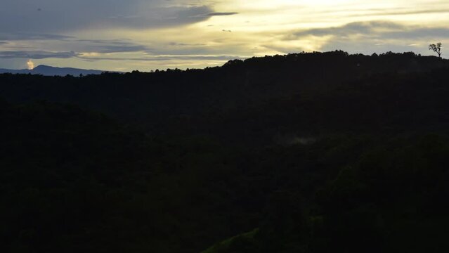 Timelapse video of fog and clouds floating in mountains covered with trees. Beautiful calm nature in wet season