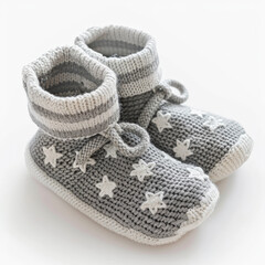 Cute baby booties in soft grey with a star pattern, isolated on white background