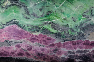 Naklejka premium Processed collage of zoisite tanzanite gemstone purple and green texture. Background for banner