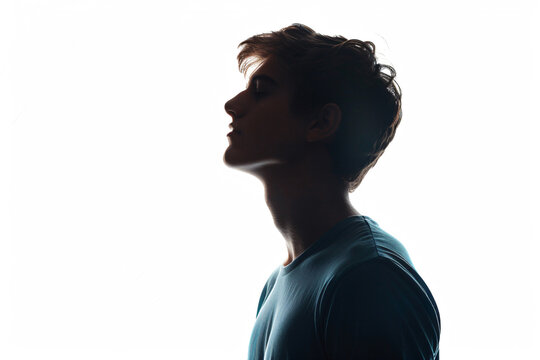 Silhouette of handsome man in black t-shirt on white background, isolated portrait of young guy with short hair and sidecut looking up, profile view, isolated


