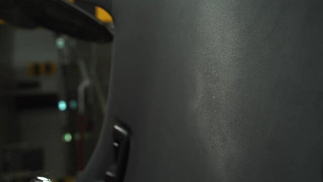 4k vertical video Hand cleans car ceiling with detergent and microfiber rug. Detailing car headliner covering. Spraying detergent on the headliner in car.