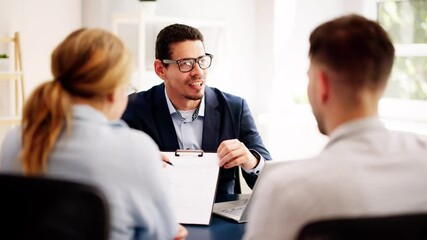 Financial consultant explaining new project investment to young couple in office