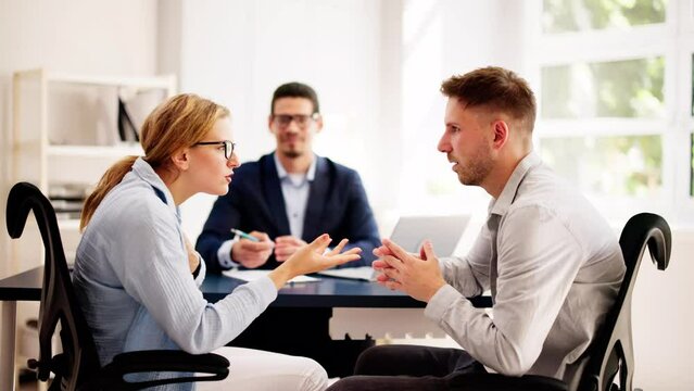 Professional lawyers mediating a tense argument between a young Hispanic couple
