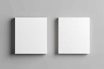 Fototapeta premium Minimalist white blank canvases against a plain gray wall, perfect for artwork or creative projects.