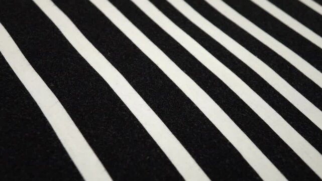 White thin fabric with wide black stripes, slow motion, background