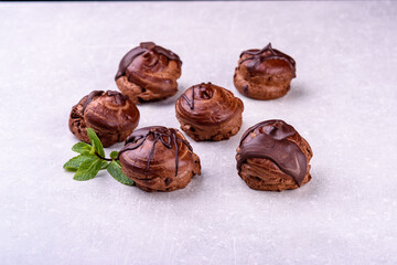 Chocolate profiteroles on a gray background for a coffee shop menu