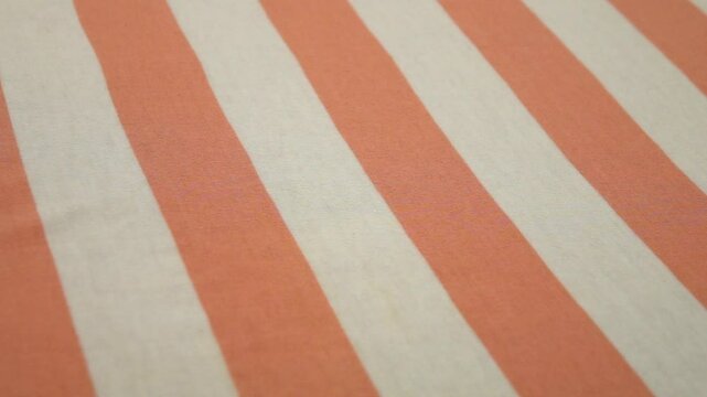 White thin fabric with wide orange stripes, background, slow motion