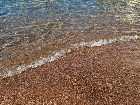 Sea gentle waves on sand beach 