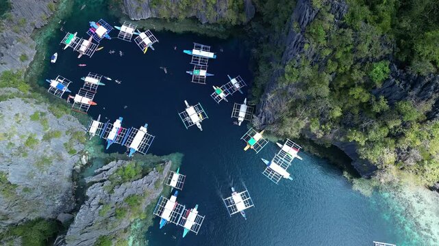 Twin Lagoon in Coron Island, Philippines, with boats gently sailing through.