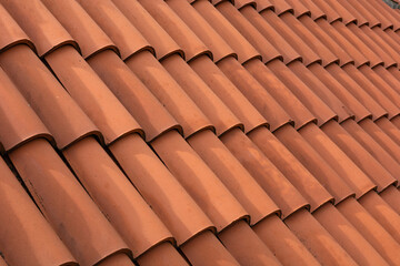 New red corrugated roof tile element on a house on a sunny day. Shingles roofing surface tiles overlay pattern and texture