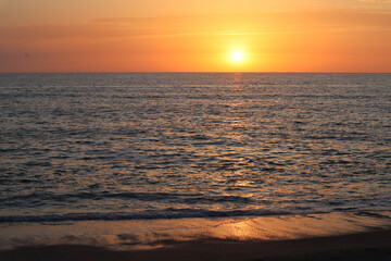 Sunset on the beach on the sea coast of Italy, Calabria. Holidays at sea.