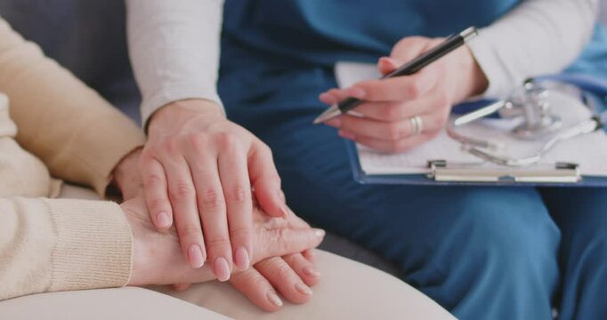 Hand clap gentle gesture close up, senior, young person in considerate, kindly caring emotion. Nurse, caregiver feeling, showing, expressing sympathy to old woman, patient delicate or soothing gesture