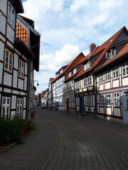 Narrow street paved with cobblestones is winding through a picturesque german town with traditional half-timbered houses, Wolfenbüttel, Germany