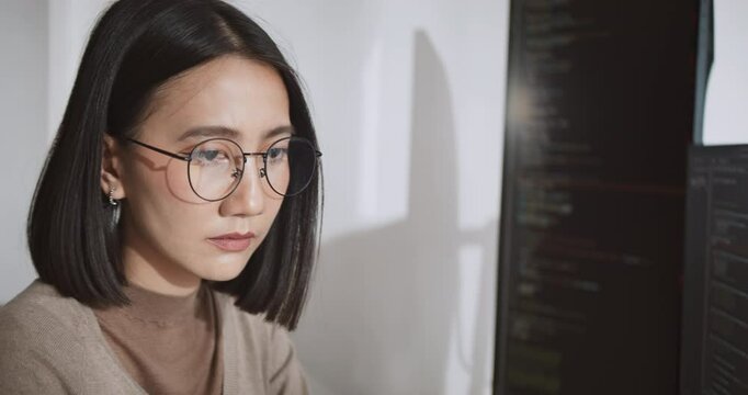 Young adult Asian male, female software developer coding program on desktop computer. Man, woman work from home, remote working, freelance programmer job, smart digital nomad lifestyle concept