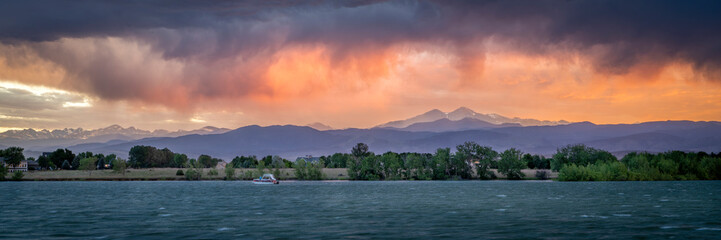 dramatic, stormy sunset with high wind over Longs Peak and Front Range of Rocky Mountains in northern Colorado