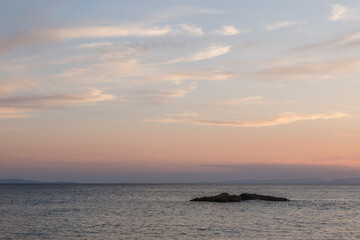 Beautiful cloudy sky over calm blue sea at sunset
