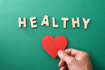 Healthy life with hand holding cutout and word healthy