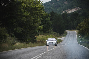 Cars drive along the highway that passes through the beautiful mountainous region of Bulgaria