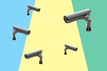 Few security cameras on colorful wall. Minimal creative concept.