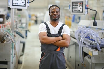 Portrait of industrial engineer. factory worker standing in factory production line