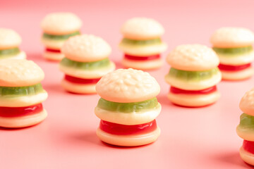 Colorful candy hamburgers on pink background. Minimal food concept.