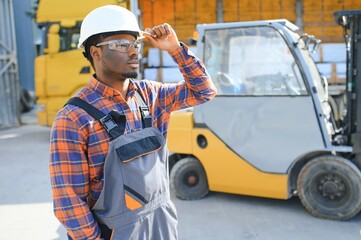 African American Man at work. Professional operation engineering. Young worker forklift driver