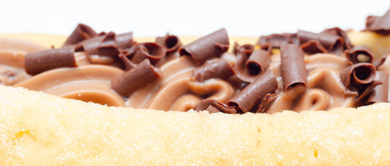 A chocolate covered doughnut with chocolate chips on top