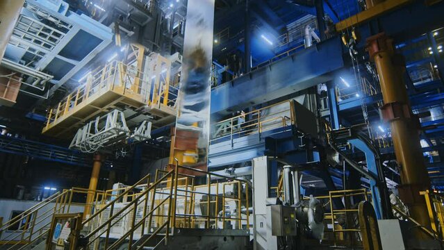 The sheet of metal is pulled upward after the evaluation bath