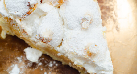 A slice of pie with a lot of powdered sugar on top