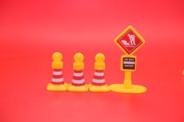 miniature traffic cones and do not enter signs isolated on a red background