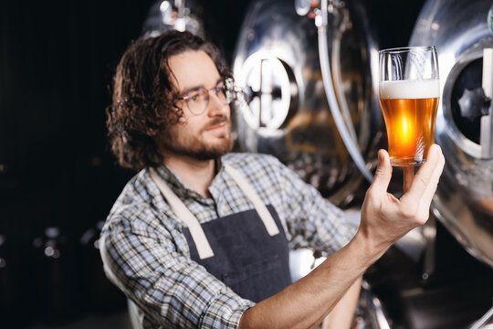 Control quality of craft beer, Owner of Brewery factory, inspector checking drink. Brewer man working on alcohol manufacturing production - Powered by Adobe