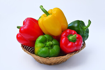 colorful paprika in a basket isolated on white background