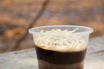 Steamed brownies and soft jelly with chocolate flavor and cheese topping. sweet food in plastic cup packaging.