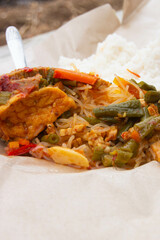 wrapped rice with side dishes, vegetables and rice