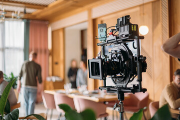 Professional film and video camera on the set. Shooting shift, equipment and group.