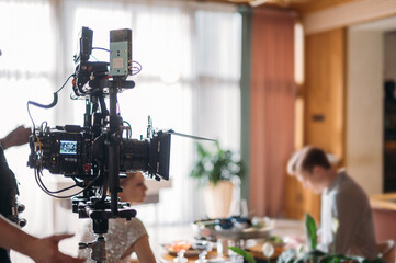 Professional film and video camera on the set. Shooting shift, equipment and group.