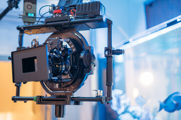 Professional film and video camera on the set. Shooting shift, equipment and group.
