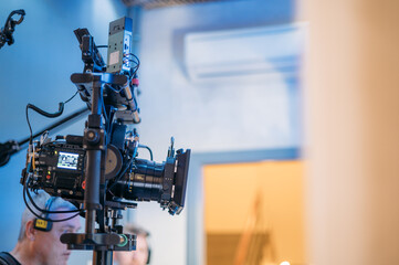 Professional film and video camera on the set. Shooting shift, equipment and group.