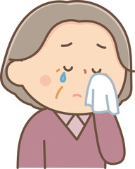 ハンカチで涙を拭くシニア女性