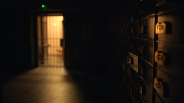 Dimly lit vault with secure safety deposit boxes for storing valuable assets and items