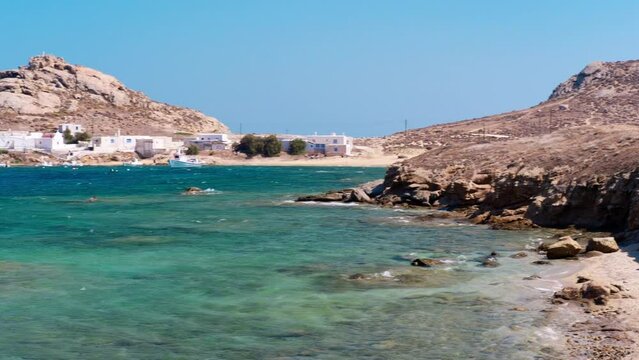 Kalafatis Beach in Mykonos, Greece. Kalafati is the beach most loved for water sports such windsurf, kitesurf, diving and snorkeling. Near the awesome view of Dragnoisi Island and Divounia,