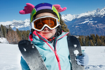 Little skier girl portrait enjoying a sunny day on the slopes