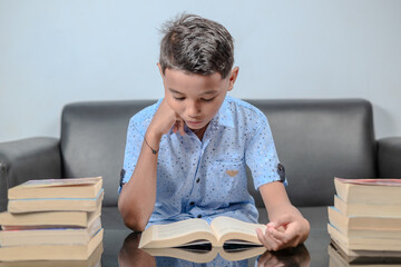 An Indonesian boy is reading a book