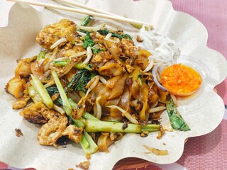 a portion of Fried Egg Kwetiau at a Chinese restaurant, served separately with chili sauce