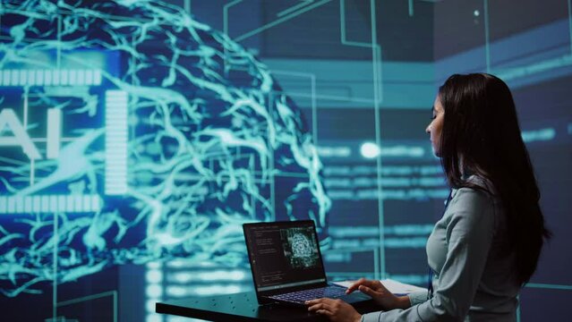 AI computer scientist using laptop for business data analysis in high tech workspace. Close up shot of Indian woman working on notebook to automatize tasks using artificial intelligence, camera B